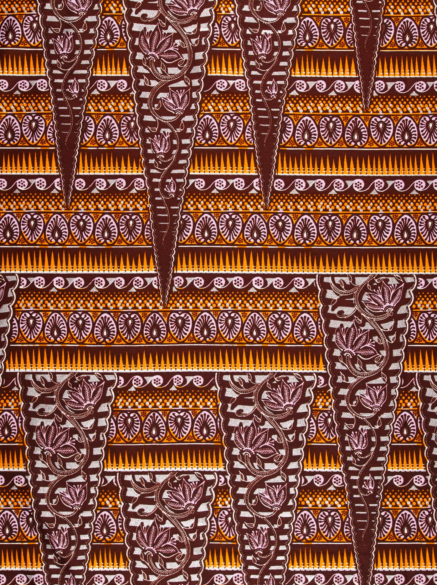 Brown and tan patterned African fabric in Wax Hollandais design, showcasing silver embellishments
