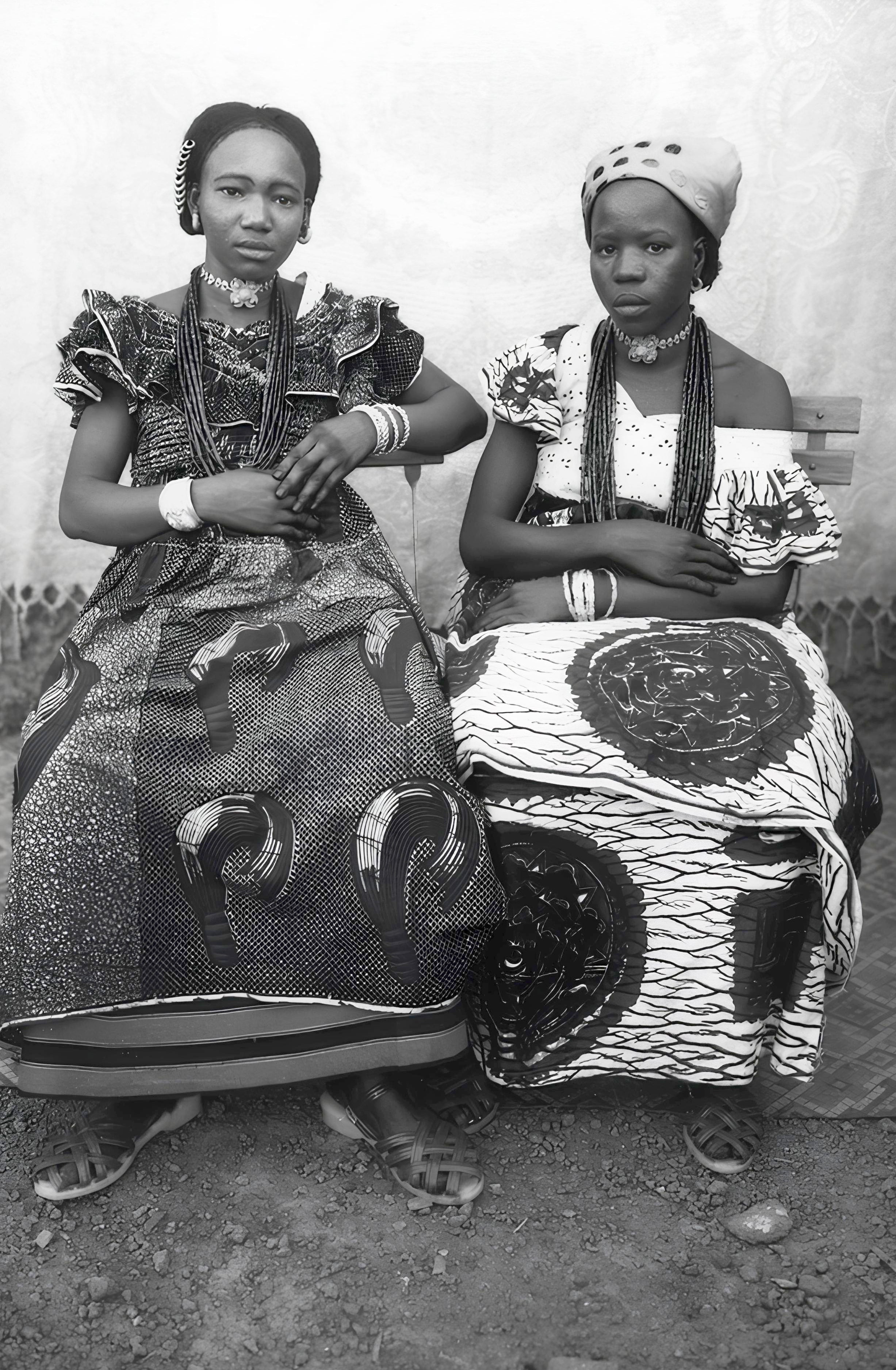 Seydou Keïta photograph of two women in traditional African dresses and jewelry, reflecting Malian culture and timeless portraiture.