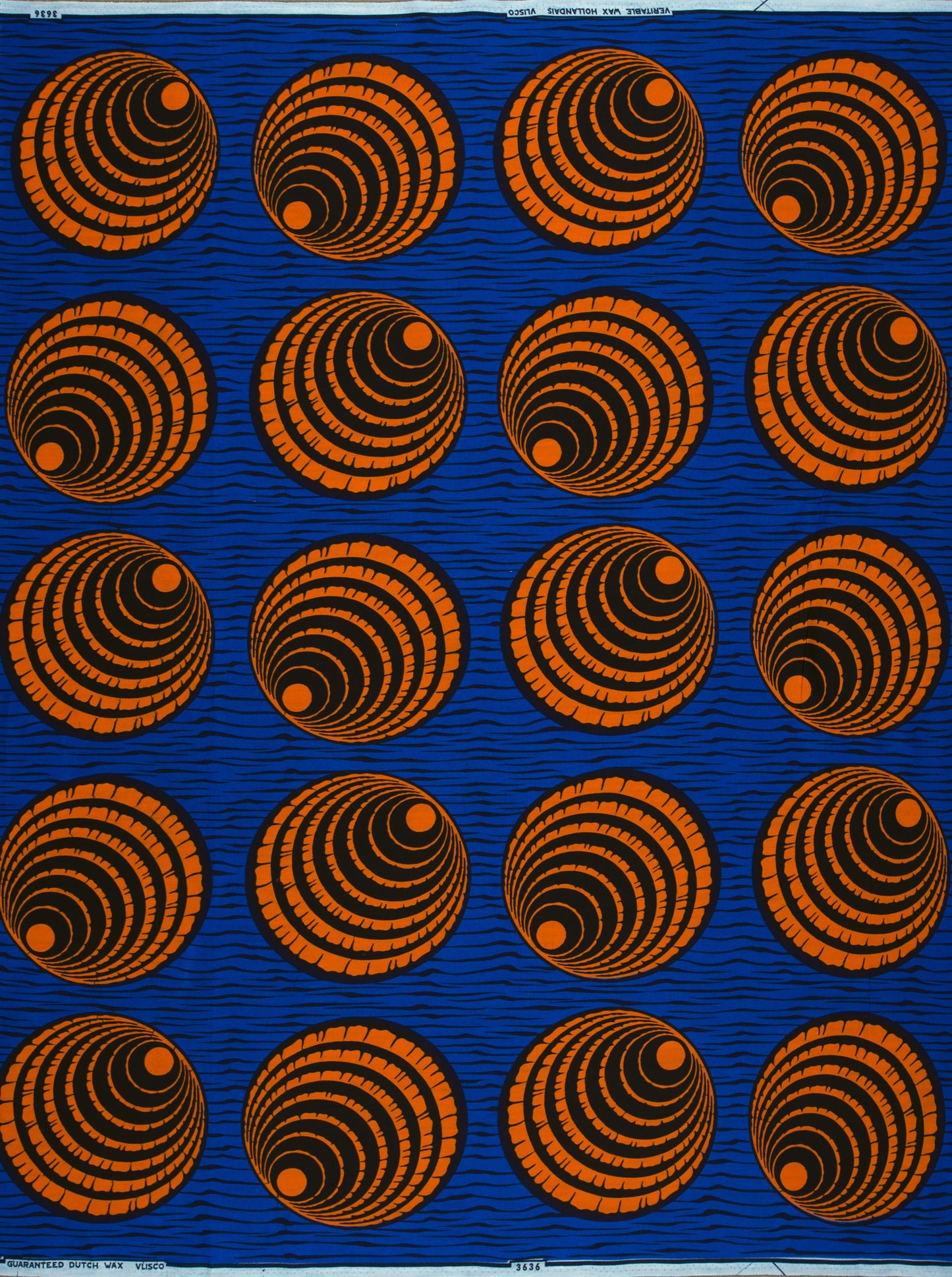 Blue Wax Hollandais fabric featuring orange and black concentric circles design