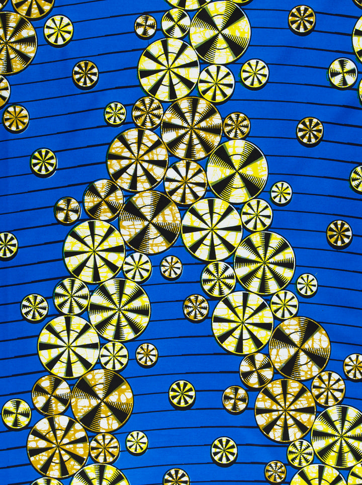 Blue fabric featuring yellow and black circular patterns with a bubble effect in expressive design